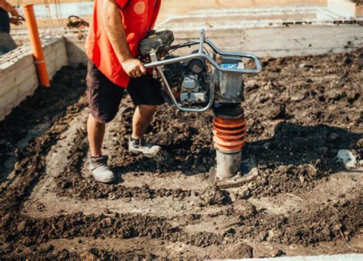 How do you compact soil for a concrete slab?