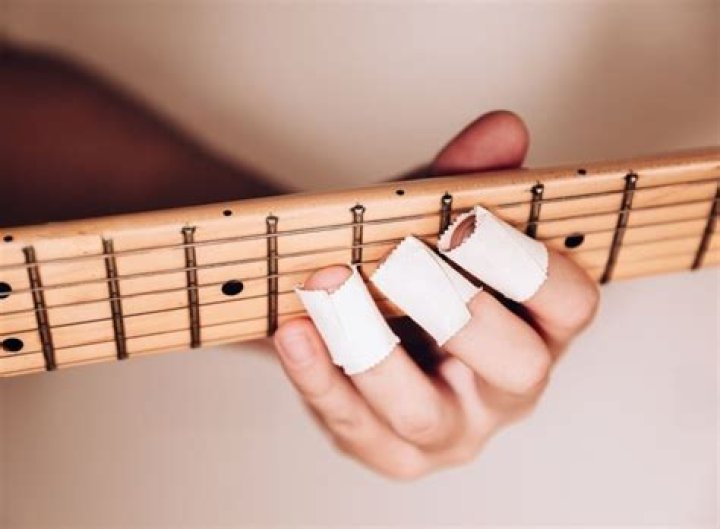 Why do guitar players tape their fingers?